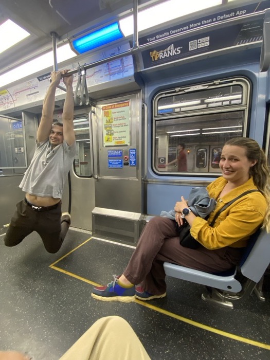 Michal and Austin goofing around on a subway train