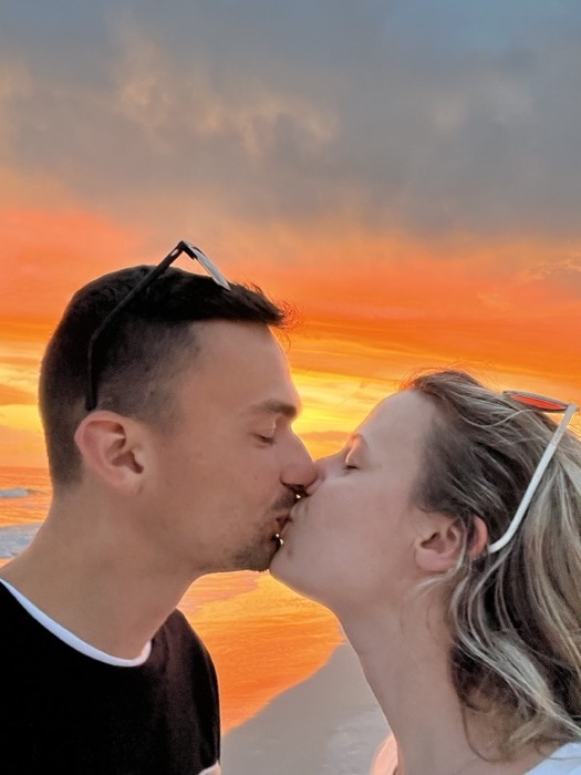Michal and Austin kissing at sunset